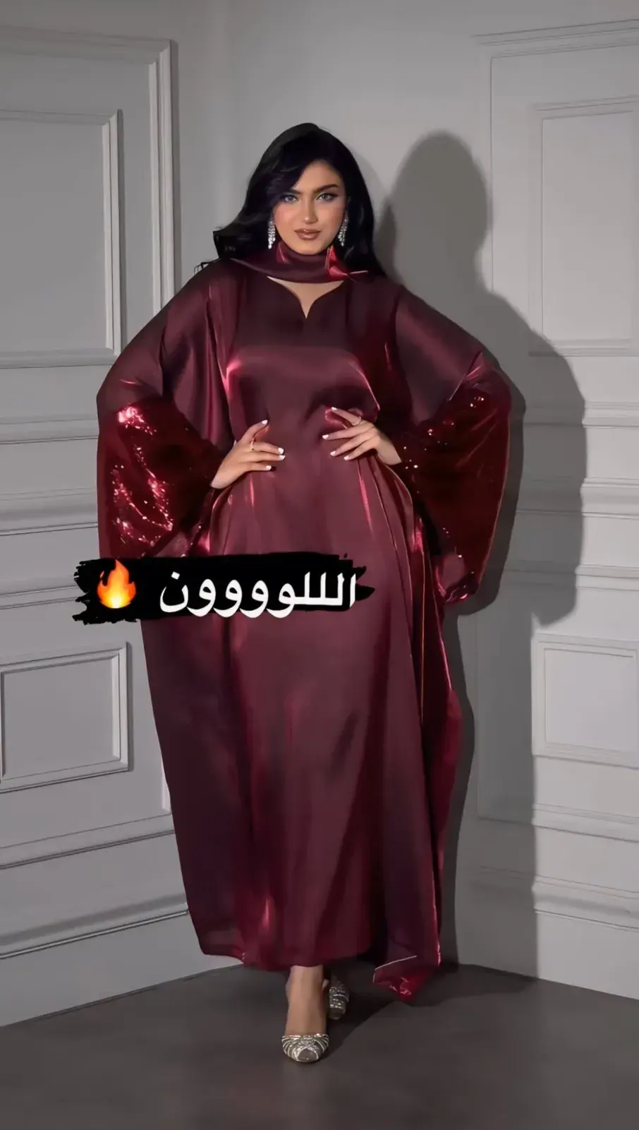 Model in a garnet satin kaftan with batwing sleeves