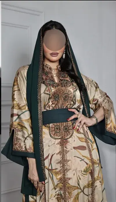 Model in a sand botanical-print kaftan with a forest-green hood and sash