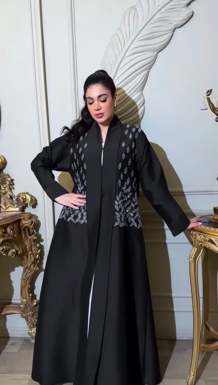 Model in a black open abaya with silver embellished front panels
