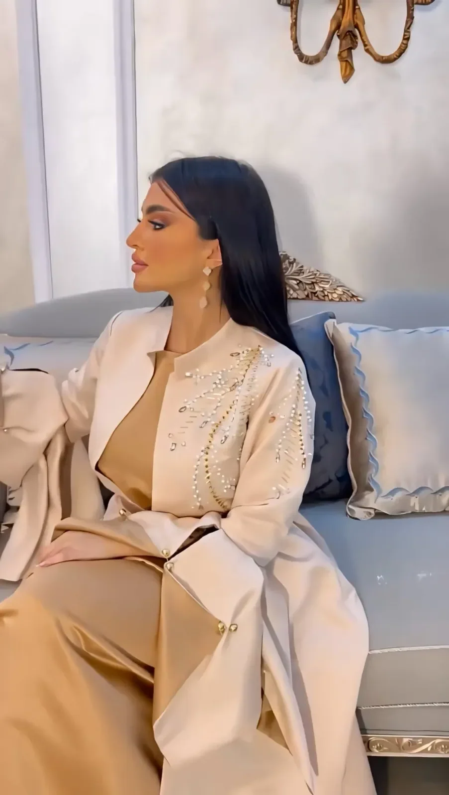 Model in a champagne robe trimmed with pearls over a matching dress