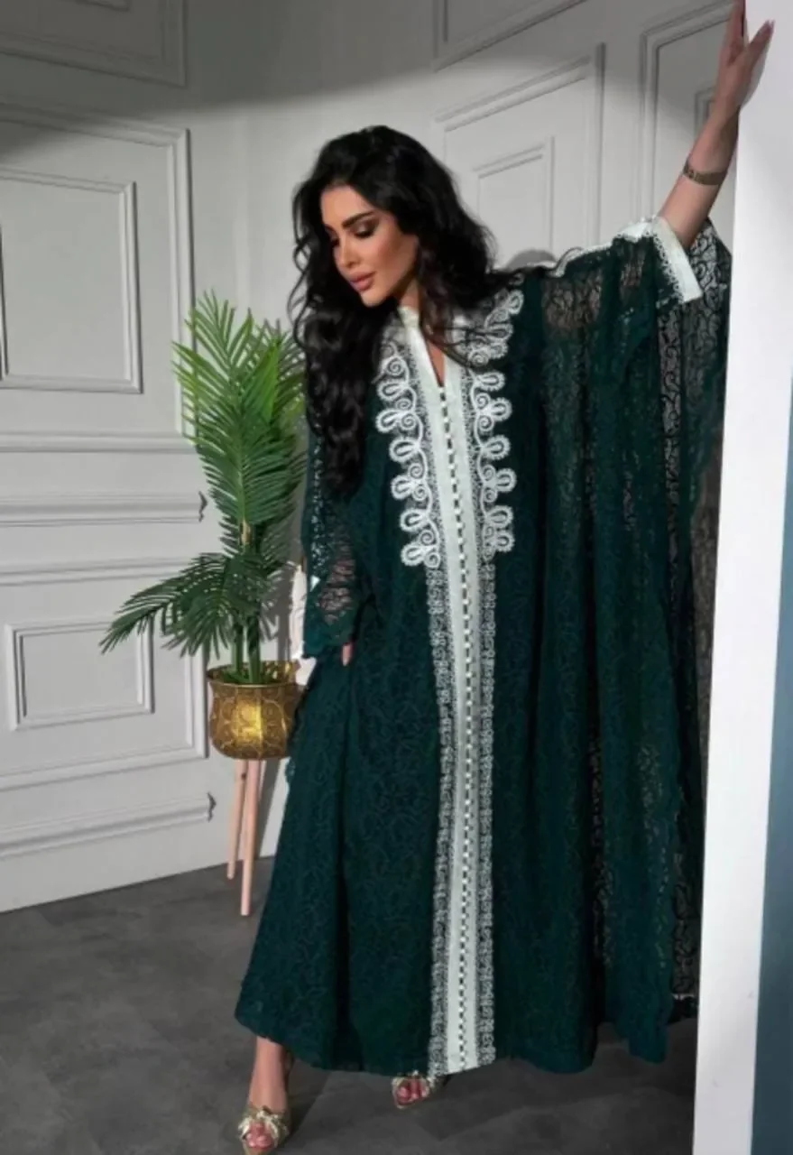 Model in an emerald lace bisht kaftan with ivory embroidered trim