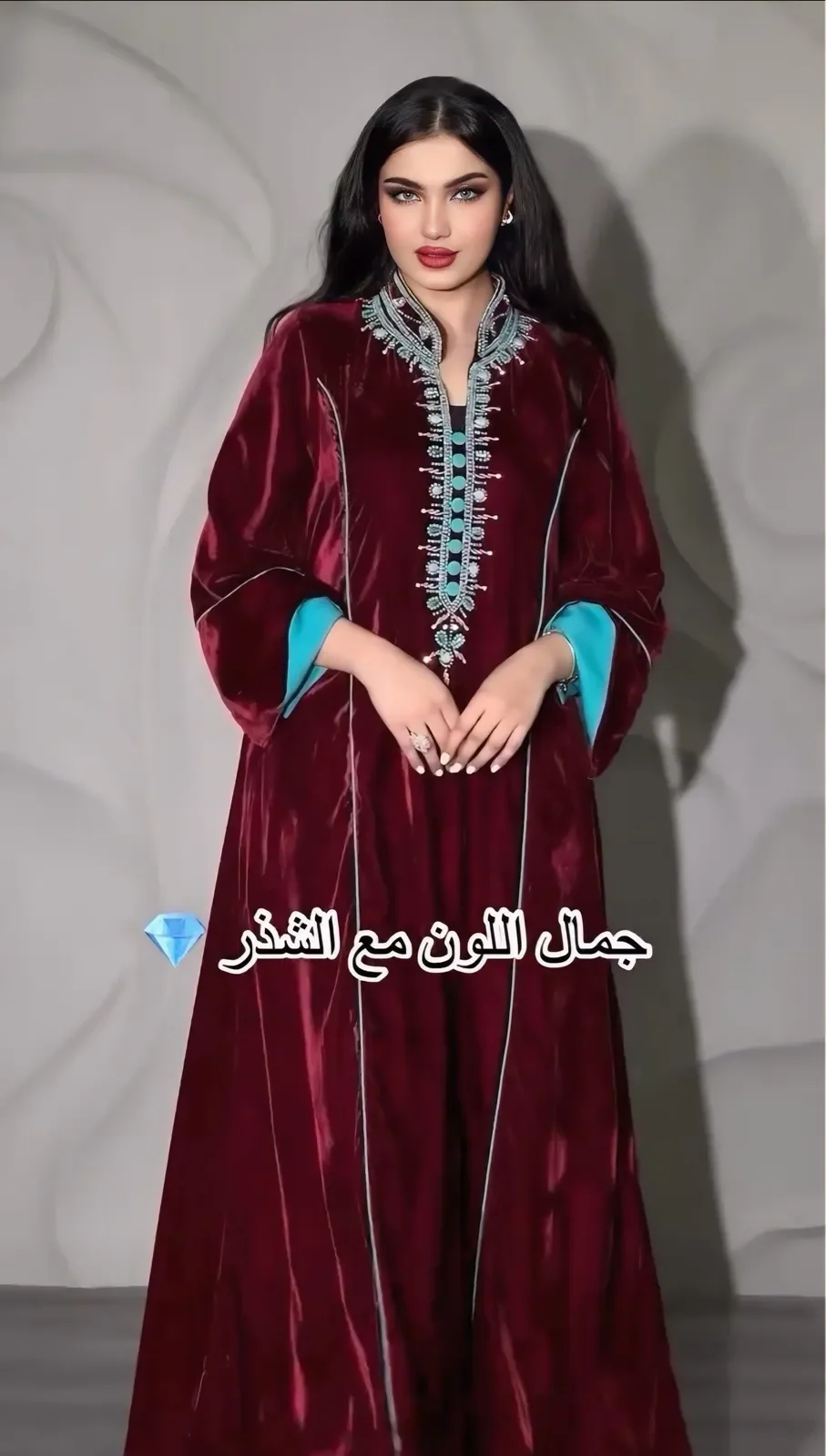 Model in a garnet velvet jalabiya with a beaded neckline and turquoise-lined sleeves