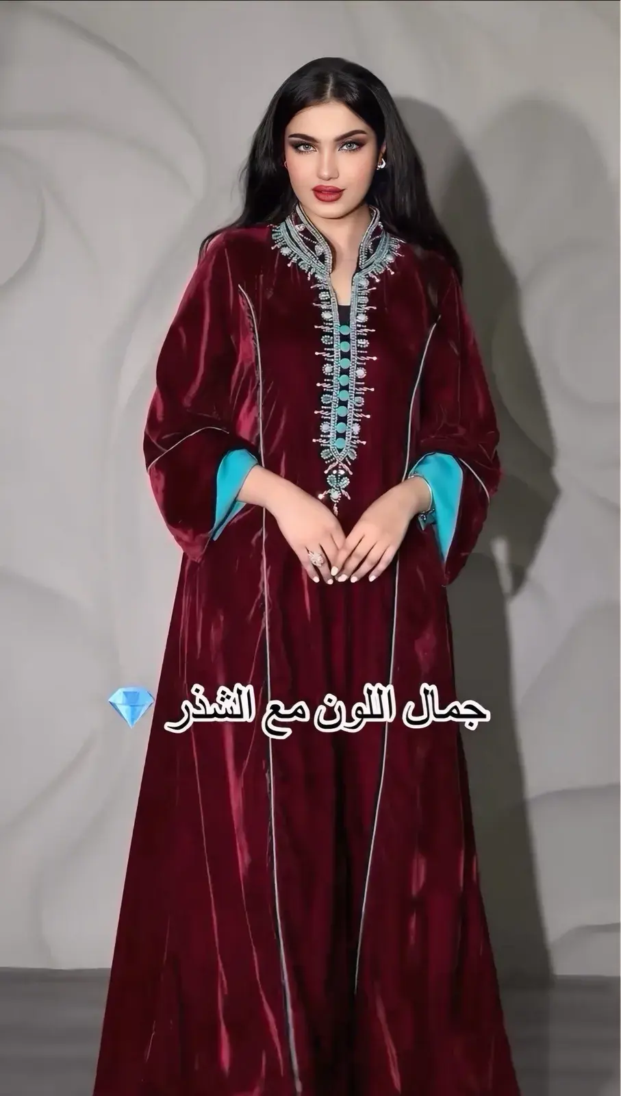 Model in a garnet velvet jalabiya with a beaded neckline and turquoise-lined sleeves